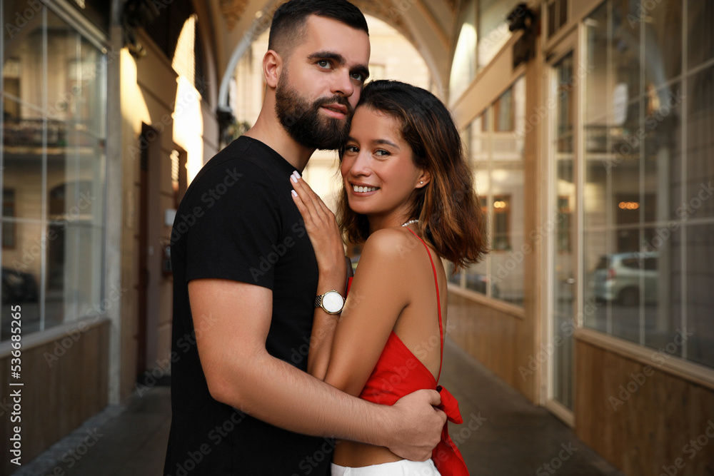 Happy young couple hugging on city street Happy young couple hugging on city street