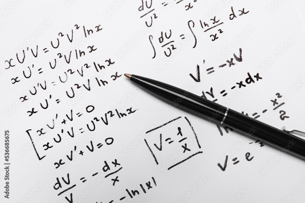 Sheet of paper with mathematical formulas and pen, top view Sheet of paper with mathematical formulas and pen, top view