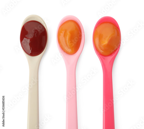 Spoons of tasty pureed baby food isolated on white, top view