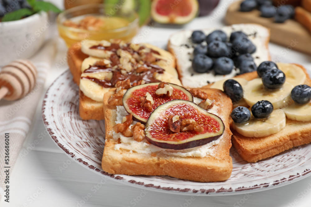 Different sweet delicious toasts on plate, closeup Different sweet delicious toasts on plate, closeup