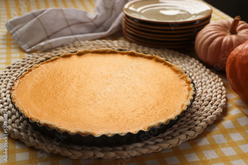 Delicious homemade pumpkin pie in baking dish on table