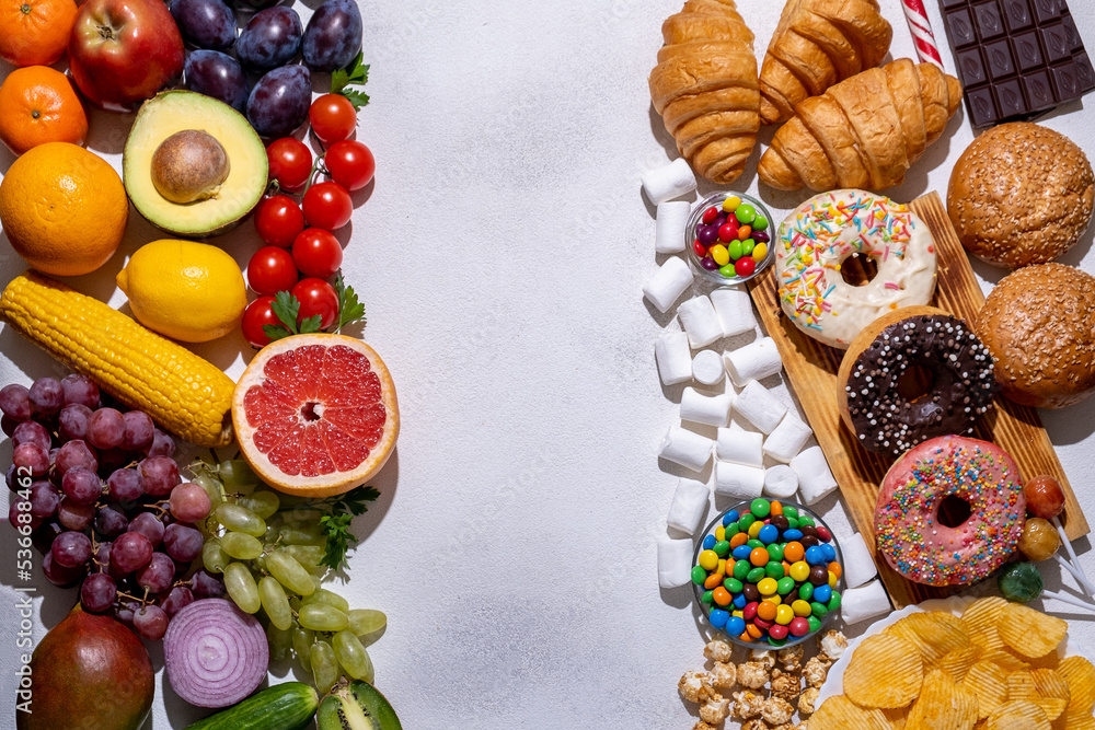 Healthy food, fruits, vegetables and junk food, donuts and sugar on a