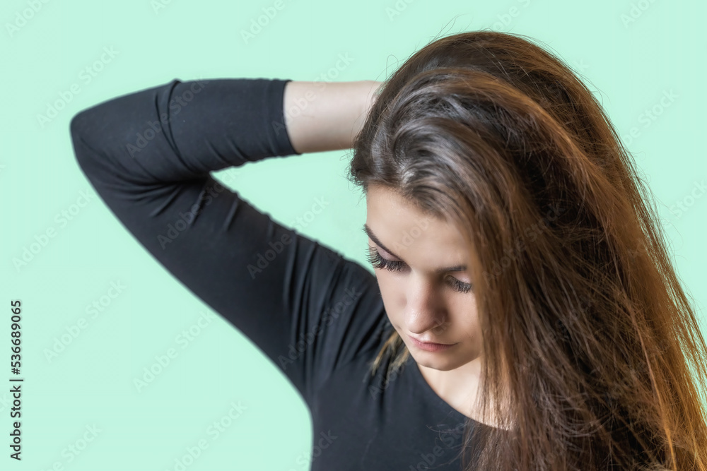 Portrait of beautiful sad girl on the green background. Horizontally. Portrait of beautiful sad girl on the green background. Horizontally.