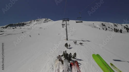 HYPERLAPSE Skiing. Action camera of skier going downhill on alpine ski on snow slopes in the mountains. Man going downhill on ski having fun on slopes. Winter sport outdoor activity video