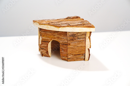 a small wooden house for a hamster and a mouse on a white background.  photo