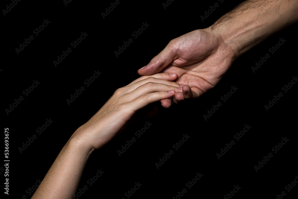 Gentle touch of female and male hands on a black background. Gesture expressing love and tenderness