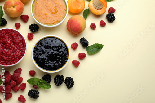 Different puree in bowls and fresh ingredients on beige background  flat lay. Space for text