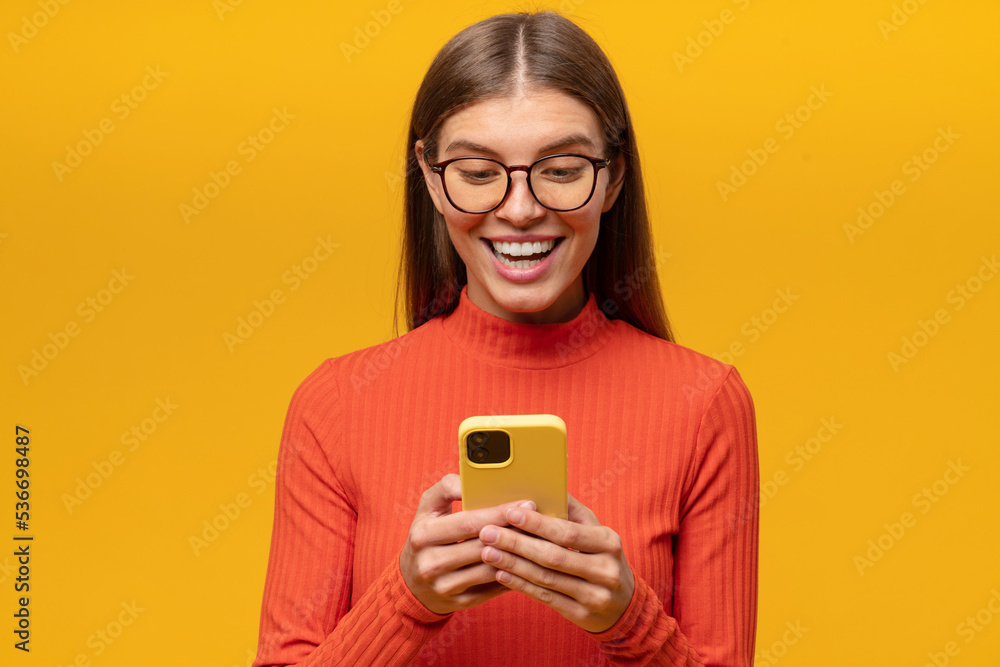 Lucky woman holding phone looking at screen with excited face reading sms with good news Lucky woman holding phone looking at screen with excited face reading sms with good news