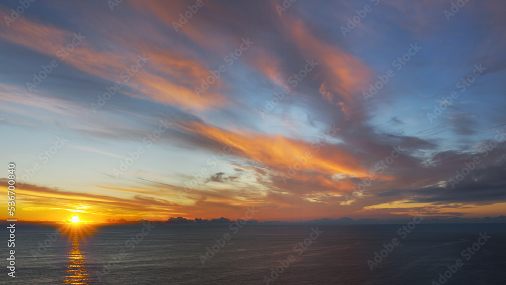 Breathtaking sunset in the calm ocean at the Cabo da Roca, Portugal.