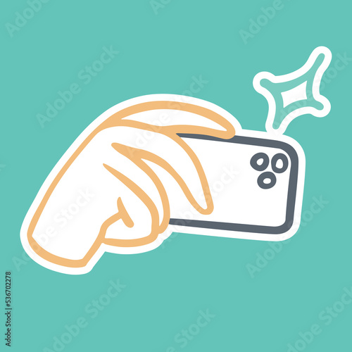 The hand holds a horizontal phone and takes a photo. Mobile photo, sticker, icon in vector doodle simple outline style with stroke.
