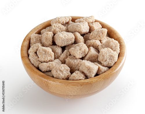 Cubes of brow cane sugar in wooden bowl isolated on white background with clipping path