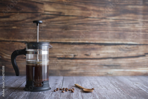 French press coffee on table with wooden background