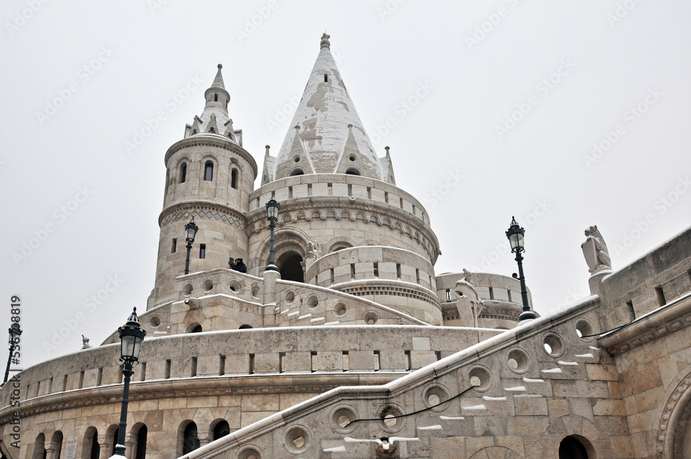 Fisherman`s Bastion in Budapest, Hungary, in a cold snowy and foggy winter day