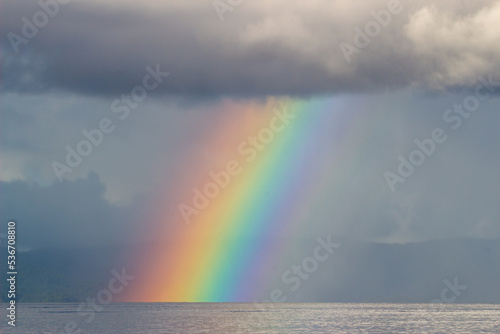 Rainbow from the clouds to the sea