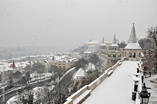 Fisherman`s Bastion in Budapest, Hungary, during cold snowy and foggy winter day