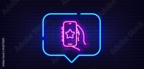 Neon light speech bubble. Favorite app line icon. Hand hold phone sign. Cellphone with screen notification symbol. Neon light background. Favorite app glow line. Brick wall banner. Vector