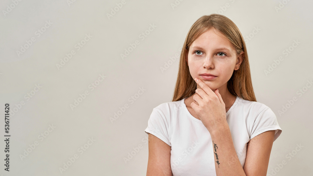 Cropped of blonde caucasian teenage girl thinking Cropped of blonde caucasian teenage girl thinking