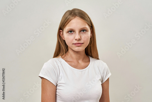 Serious caucasian teenage girl looking at camera