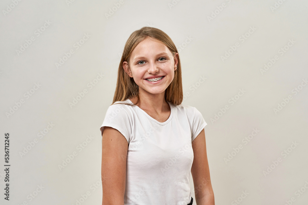 Smiling teenage girl with braces looking at camera Smiling teenage girl with braces looking at camera