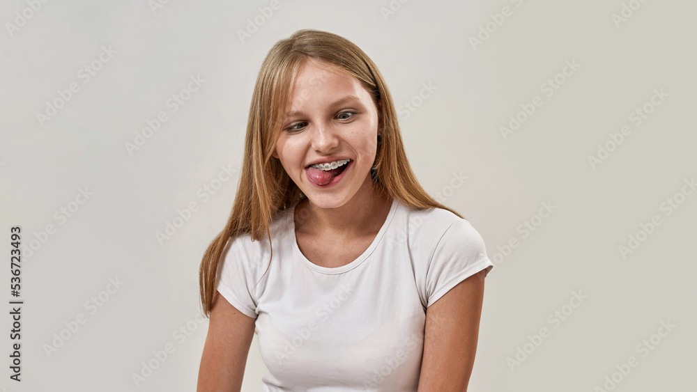 Partial of teenage girl joke and stick out tongue Partial of teenage girl joke and stick out tongue