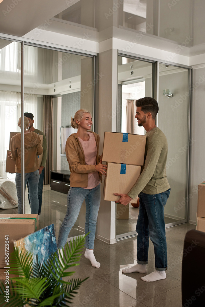 Girl help man carry cardboard boxes with things Girl help man carry cardboard boxes with things