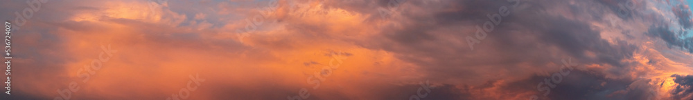 Wide sky panorama with bright sunset clouds