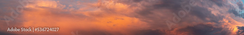 Wide sky panorama with bright sunset clouds