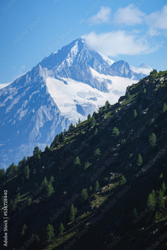 The landscape of the Swiss Alps, with the highest peaks and glaciers of the canton of Valais viewed from the Simplon Pass, Switzerland - July 2022.