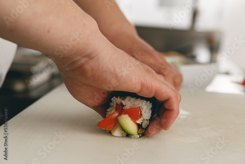 Close up of man japanese restaurant chef cooking sushi in the kitchen 