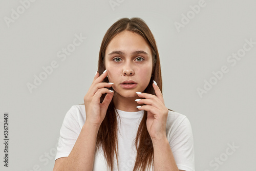Portrait of worried female teenage look at camera