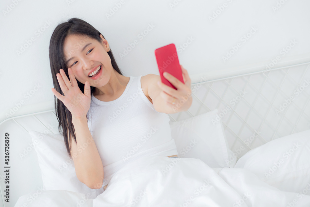 Young asian woman using smartphone for video conference online with friends, businesswoman working with video call for meeting with social network with smart phone, business and communication concept.