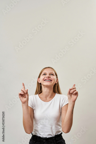 Front view of smiling teenage girl having new idea