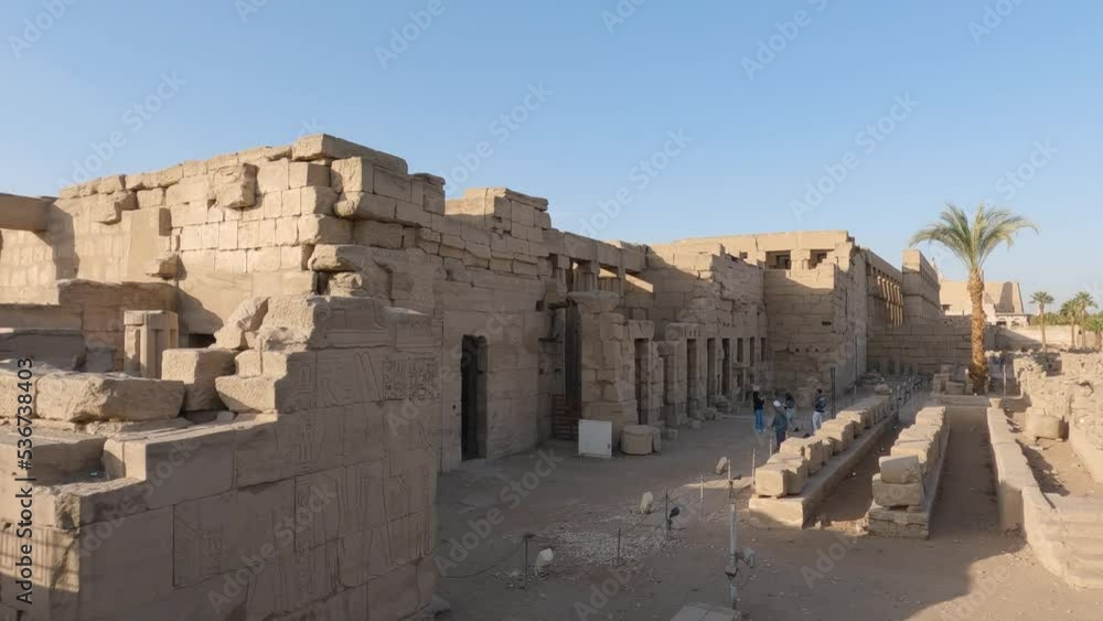 Panning shot of tourists standing outside and entering Luxor temple Panning shot of tourists standing outside and entering Luxor temple
