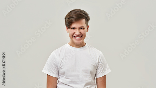 Cropped of angry teenage boy looking at camera