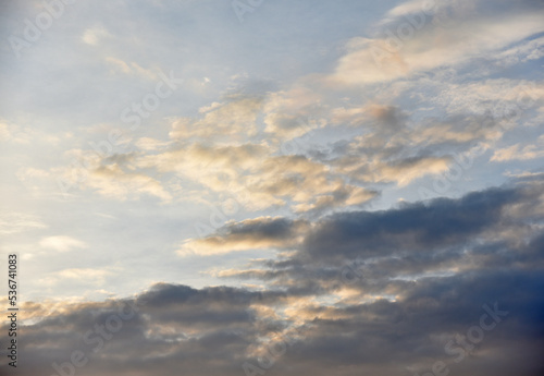 Sunset sky with pink and blue clouds in summer. Beautiful sunset with the sun.