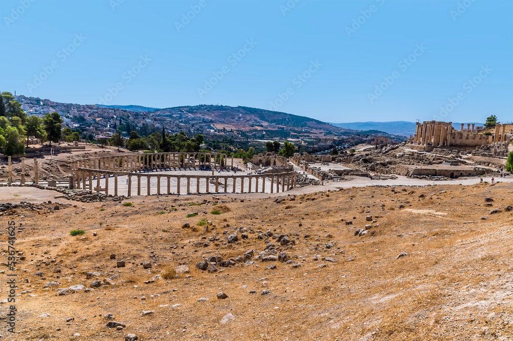 A view over the side of the Oval Plaza in the ancient Roman settlement of Gerasa in Jerash, Jordan in summertime