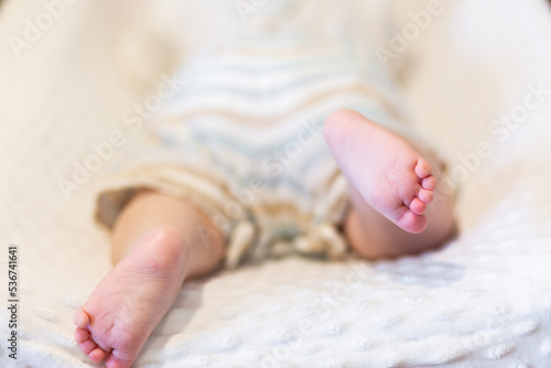 Happy baby feet kicking during tummy time on change table photo