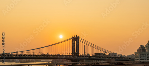 Manhattan Bridge at sunrise and some disc of the rising sun