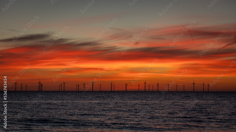 Off-shore wind farm in the North Sea at sunrise.