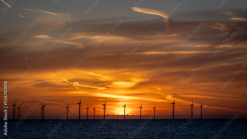 Off-shore wind farm in the North Sea at sunrise. Off-shore wind farm in the North Sea at sunrise.