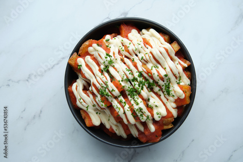 A bowl of patatas bravas photo