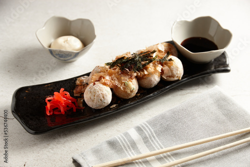 four pieces of takoyaki with soy sauce and mayonnaise