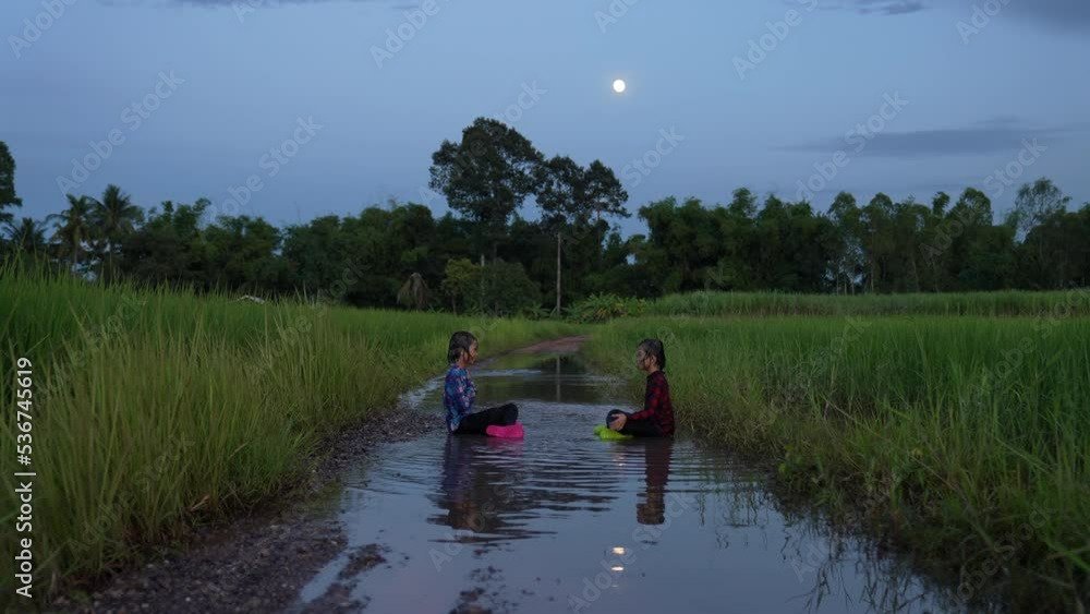 Children playing water on flooding in rural Children playing water on flooding in rural