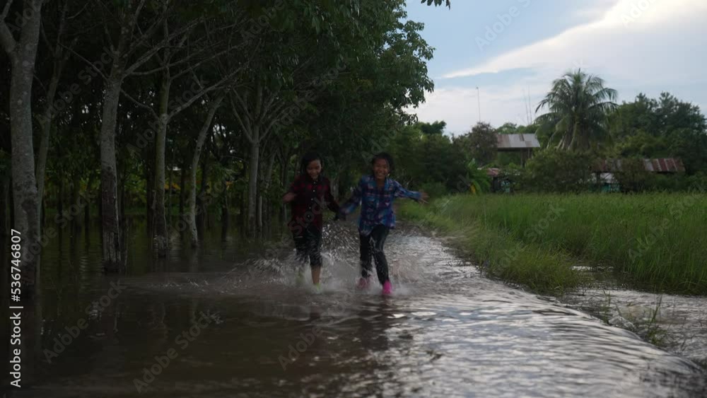 Children playing water on flooding in rural Children playing water on flooding in rural