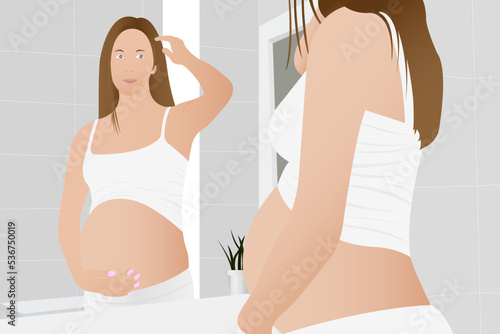 Beautiful pregnant woman, expectant mother hugging her belly with her hands.