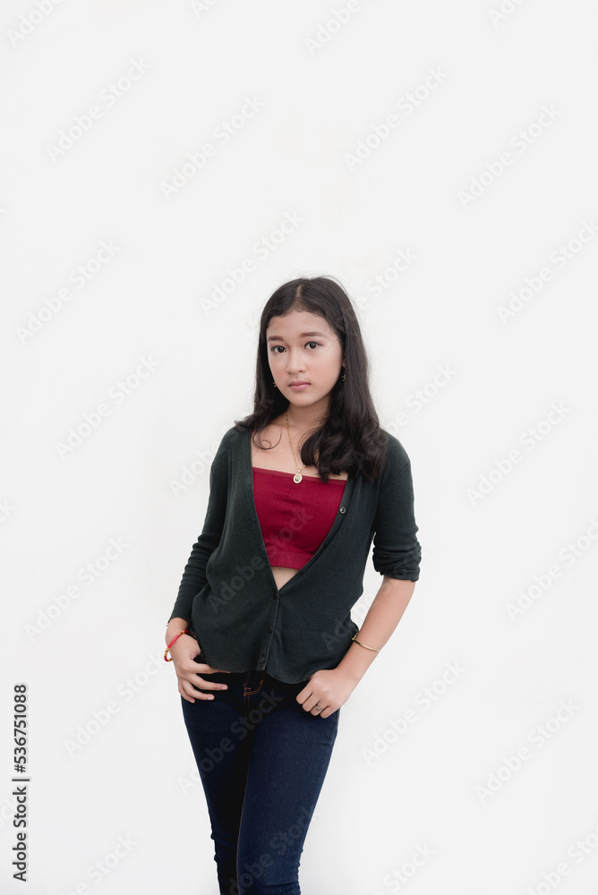A Filipina poses for the camera for a studio shot isolated on a white background. A Filipina poses for the camera for a studio shot isolated on a white background.