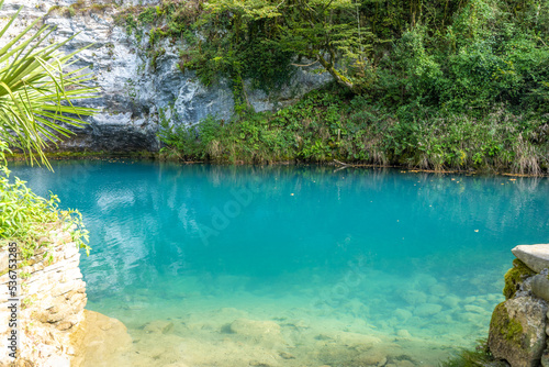 Alpine lake with clear blue water among the rocks in summer in the mountains of Abkhazia