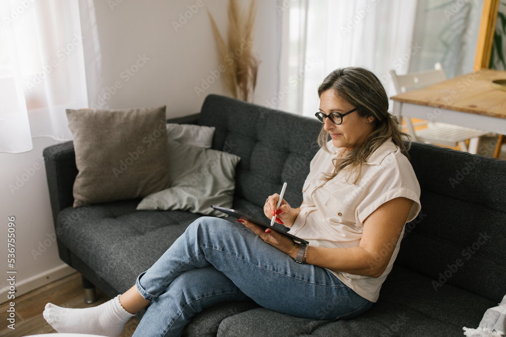 Adult woman having video call at home using tablet Adult woman having video call at home using tablet