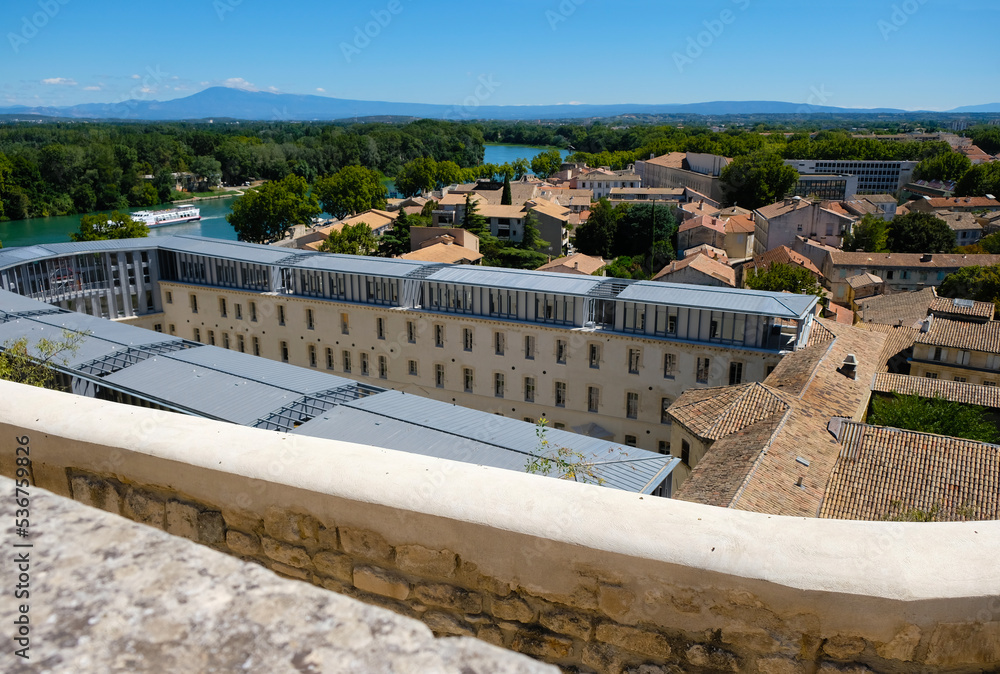 Avignon. Provence. France. August 20, 2022. A view of the reconstruction of the former St. Anne's Prison in the city's historic center. Red tiled roofs and Rhone river background.