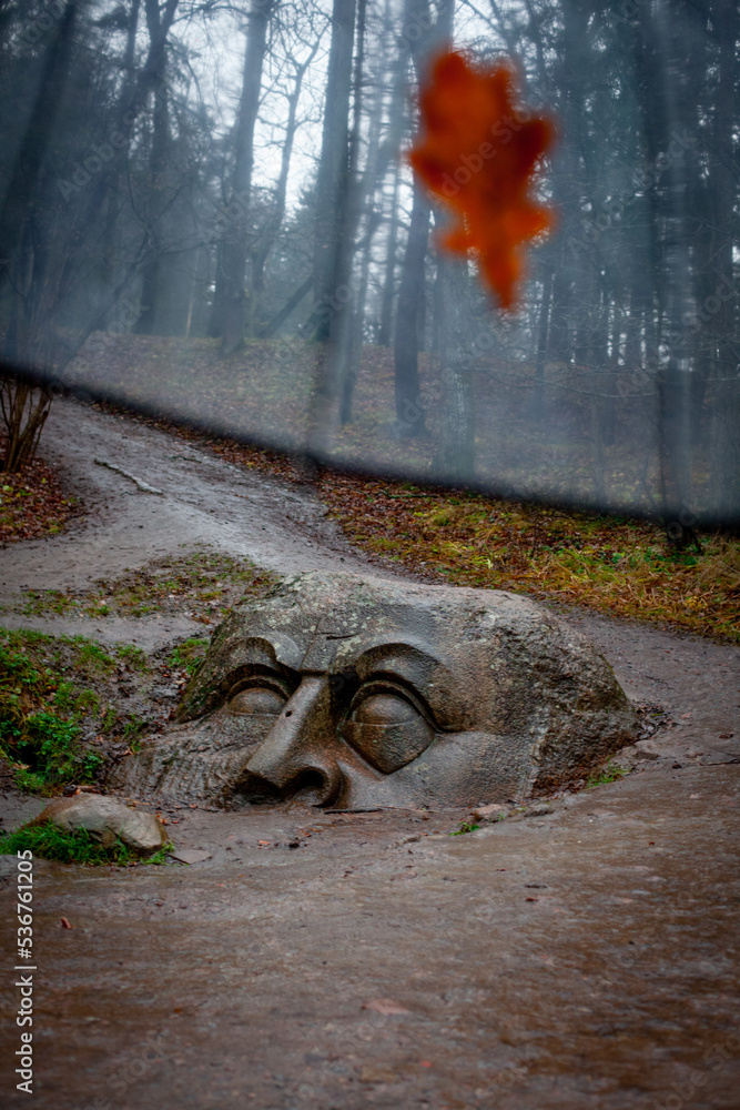 Mysterious stone head in the forest near St. Petersburg (Russia)